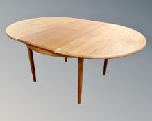 A 20th century G plan circular extending dining table fitted with internal leaf,