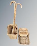 A box containing three walking sticks together with four assorted wicker baskets.