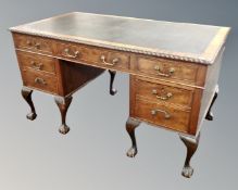 A 19th century mahogany twin pedestal desk fitted with seven drawers and leather inset panel on