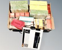 An Hanimex Rondette 150RF projector together with a box containing projector carousels, magazines,