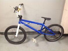 A BMX bike with rear stunt pegs.