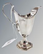 A silver helmet shaped cream jug, by W.M. Davenport, Birmingham 1909 marks.