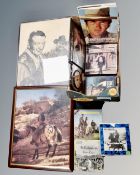 A box containing John Wayne wall clock and framed prints,