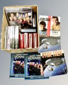 A box containing Star Wars collectibles including vintage rolled poster, calendars, books,