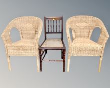 An Edwardian mahogany bergere seated bedroom chair together with a pair of wicker armchairs.
