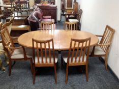 A 20th century oval teak G Plan extending dining table fitted with a leaf,
