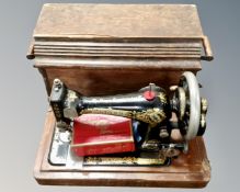 A vintage Singer hand sewing machine in case.