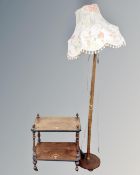 A Victorian inlaid two tier whatnot stand together with a beechwood standard lamp with shade.