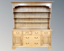 A large pine farmhouse Welsh dresser, fitted with cupboards and drawers beneath,