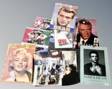 A tray containing vintage calendars including James Dean and Marilyn Monroe,