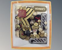A box of mixed service button and sew on badges and insignias