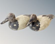 A pair of contemporary wooden duck decoys.