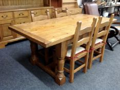 A pine farmhouse kitchen table together with four ladderback chairs.