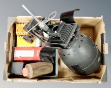 A photographic enlarger together with darkroom equipment.