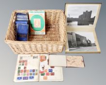 A basket containing a photograph album of monochrome photos of Newcastle and London,