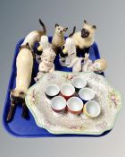 A tray containing bisque figures of babies, Persian cat ornaments,