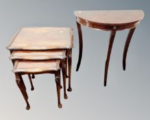 A Bevan & Funnel nest of three mahogany and beech glass topped tables together with a demi lune