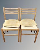 A pair of beech rush seated kitchen chairs.