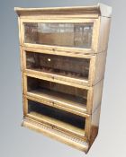 An Edwardian oak four tier stacking bookcase,