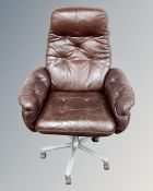 A Danish Göte Möbler office swivel reclining armchair, upholstered in a brown button leather.