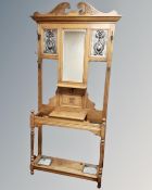 An oak Art Nouveau mirrored hall stand with inset copper panels,