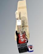 A Squire by Fender Stratocaster electric guitar on stand, with box,