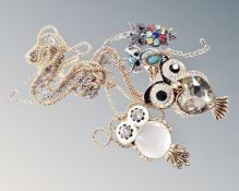 Four decorative costume owls on yellow and white metal chains.