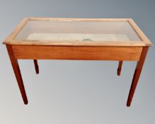 A 20th century glass topped vitrine table,