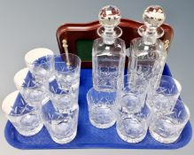 A tray containing a pair of cut glass lead crystal whiskey decanters together with a decanter stand