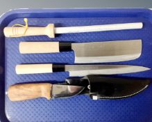 A tray containing a three piece Japanese chef's knife set together with a Norwegian Helle Besseggen