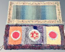 A vintage Clippy mat together with a machine made carpet runner on green ground.