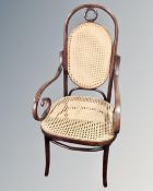 A bentwood bergere scroll armchair.