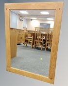 A contemporary overmantel mirror, 111cm by 84cm.