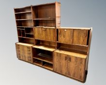 A Scandinavian rosewood three section bookcase fitted with cupboards and drawers.
