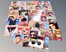 A box containing vinyl Elvis Presley LPs and 7