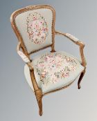 A continental carved beech salon armchair with embroidered seat.