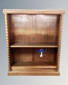 An early 20th century carved set of open bookshelves