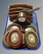 A tray containing six framed portrait miniatures of ladies, a metal embossed hand mirror,