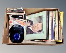 A box containing vinyl records and 7