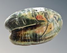 A 20th century hand painted coconut.