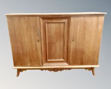 An oak and pine triple door sideboard.