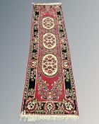 A Persian design runner, 70cm by 252cm.