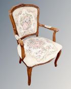 A continental carved beech salon armchair with embroidered seat.