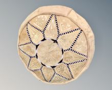 A leather pouffe footstool.