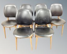 A set of six beech framed chairs in black vinyl upholstery.