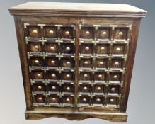 An Islamic style brass mounted double door cabinet fitted with shelves inside.