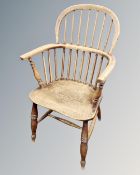 A beech spindleback kitchen armchair.