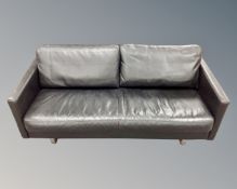 A late 20th century Scandinavian three seater black leather settee on chrome feet.