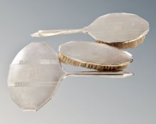 A three piece silver mounted dressing table brush and mirror set.