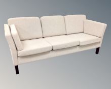 A late 20th century Scandinavian three seater settee in oatmeal fabric.